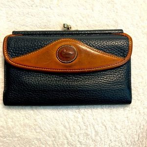 Dooney & Bourke vintage leather wallet in navy with camel colored trim.